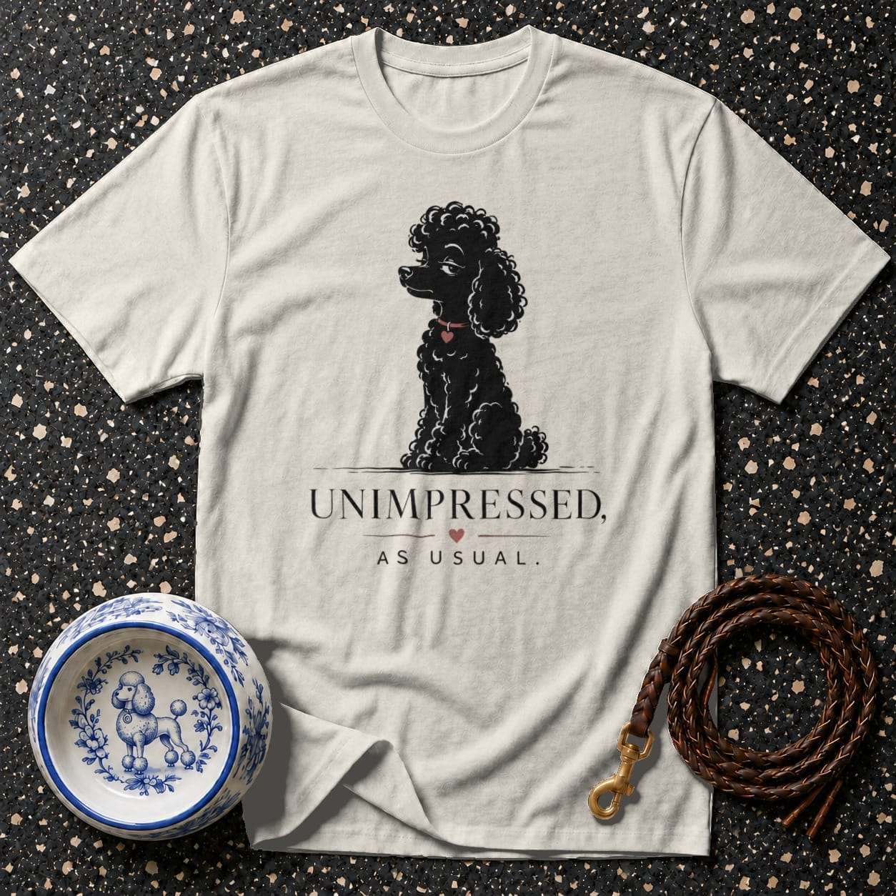 T-shirt with black poodle art and "UNIMPRESSED, AS USUAL." text.