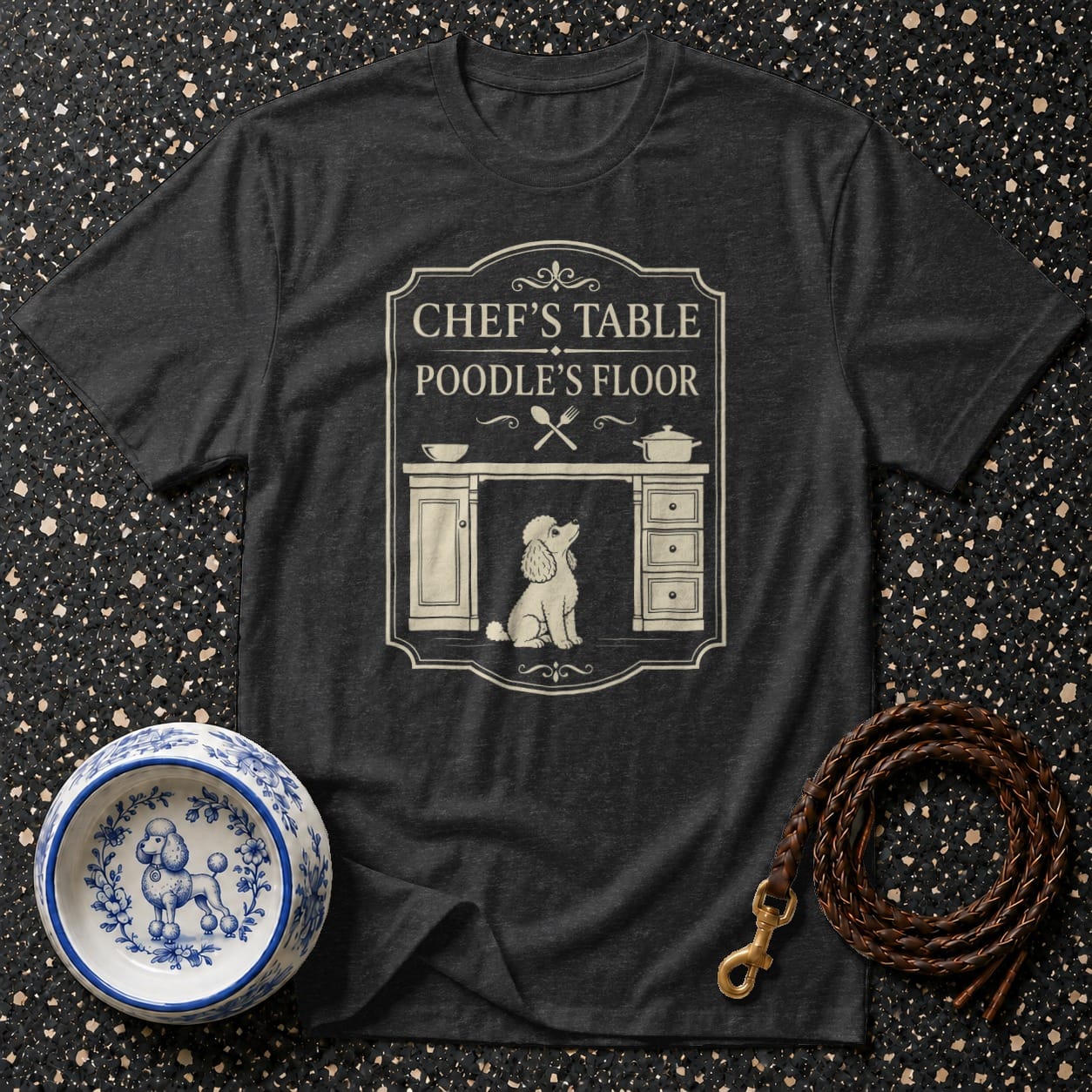 Dark t-shirt with text "Chef's Table Poodle's Floor" and a poodle graphic.