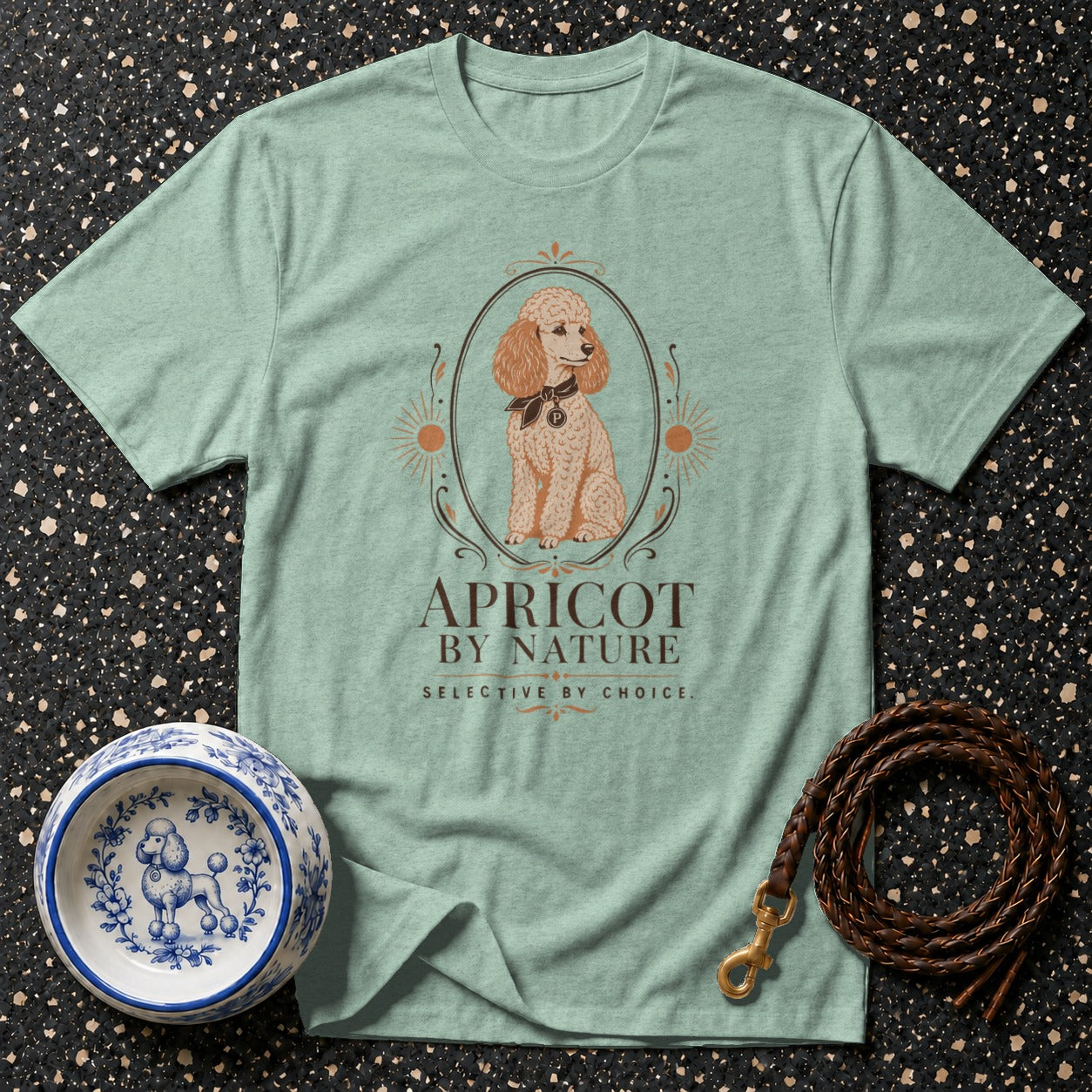Mint t-shirt with an apricot poodle illustration and "APRICOT BY NATURE" text.