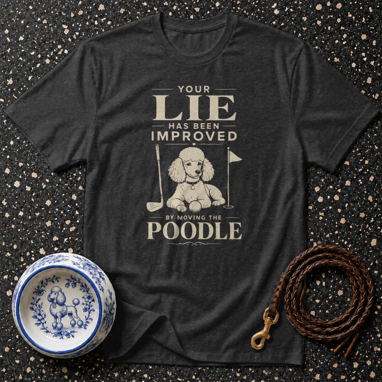 Dark t-shirt with "Your Lie Has Been Improved By Moving The Poodle" text and poodle graphic.