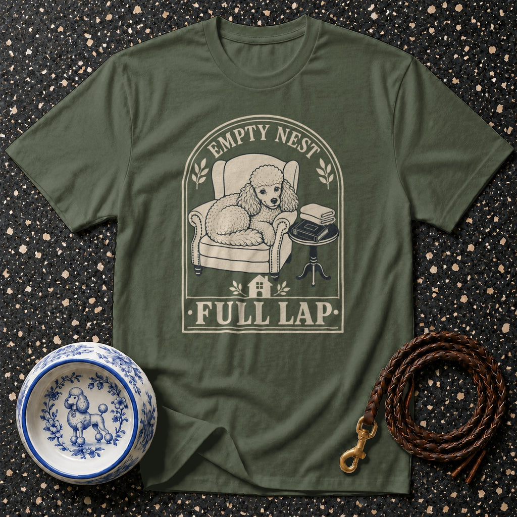 Green t-shirt with a poodle sitting in a chair, text "EMPTY NEST FULL LAP".