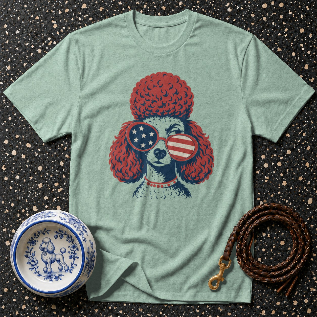 Light blue t-shirt featuring a poodle wearing patriotic sunglasses and a red collar.