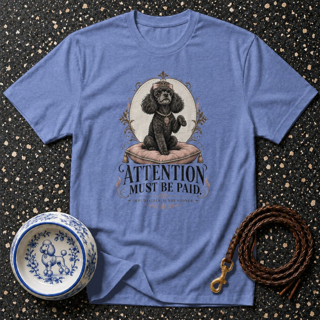 Light blue t-shirt with black poodle graphic and text "ATTENTION MUST BE PAID".