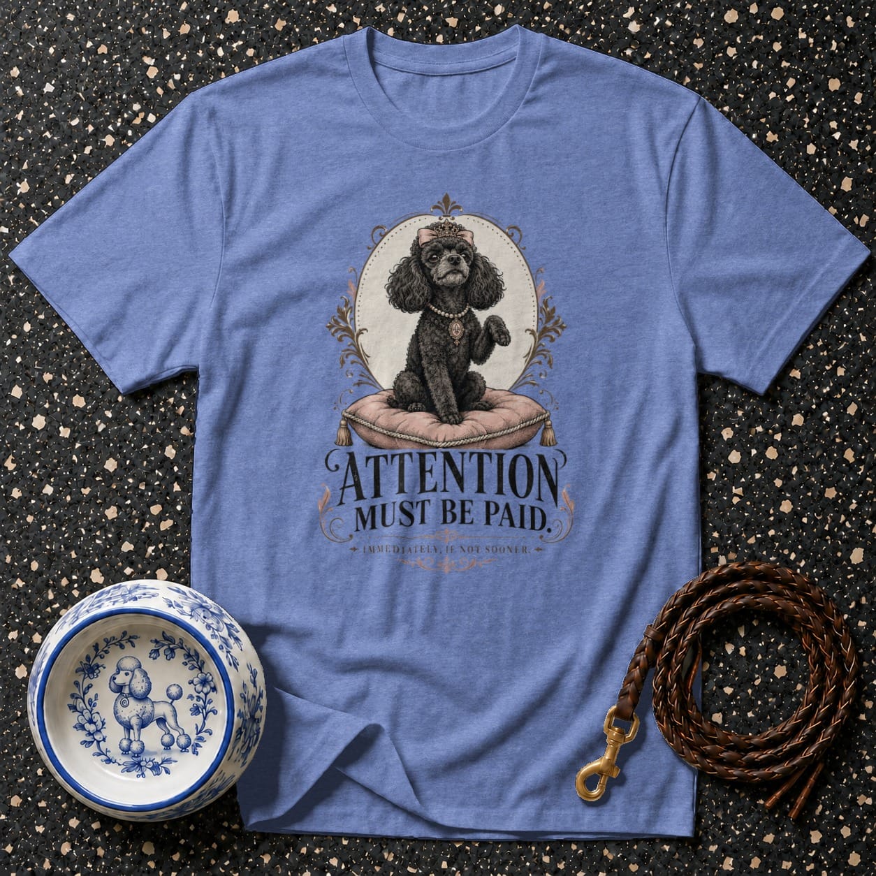 Light blue t-shirt with black poodle graphic and text "ATTENTION MUST BE PAID".