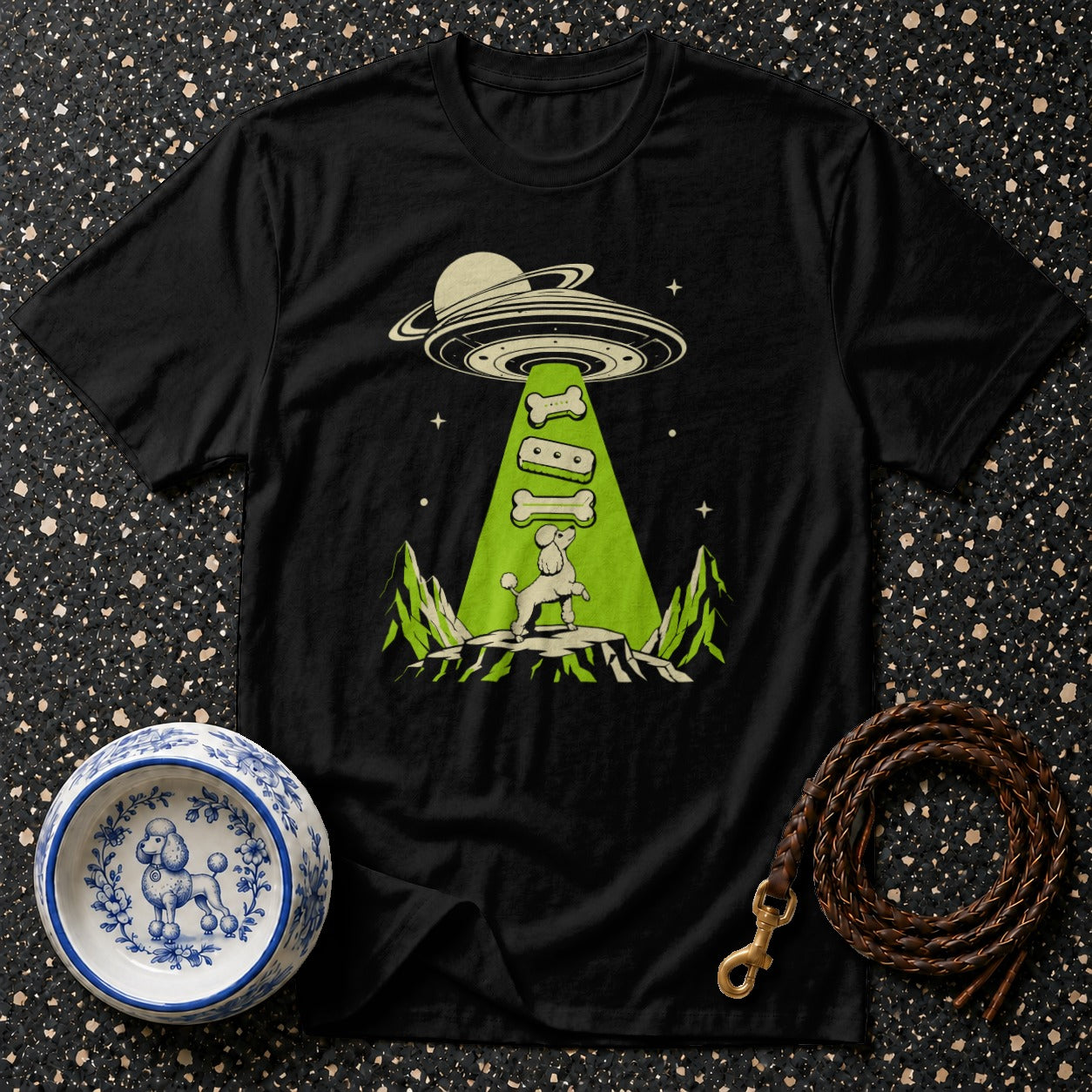 Black t-shirt with poodle graphic being abducted by a UFO with dog bones.