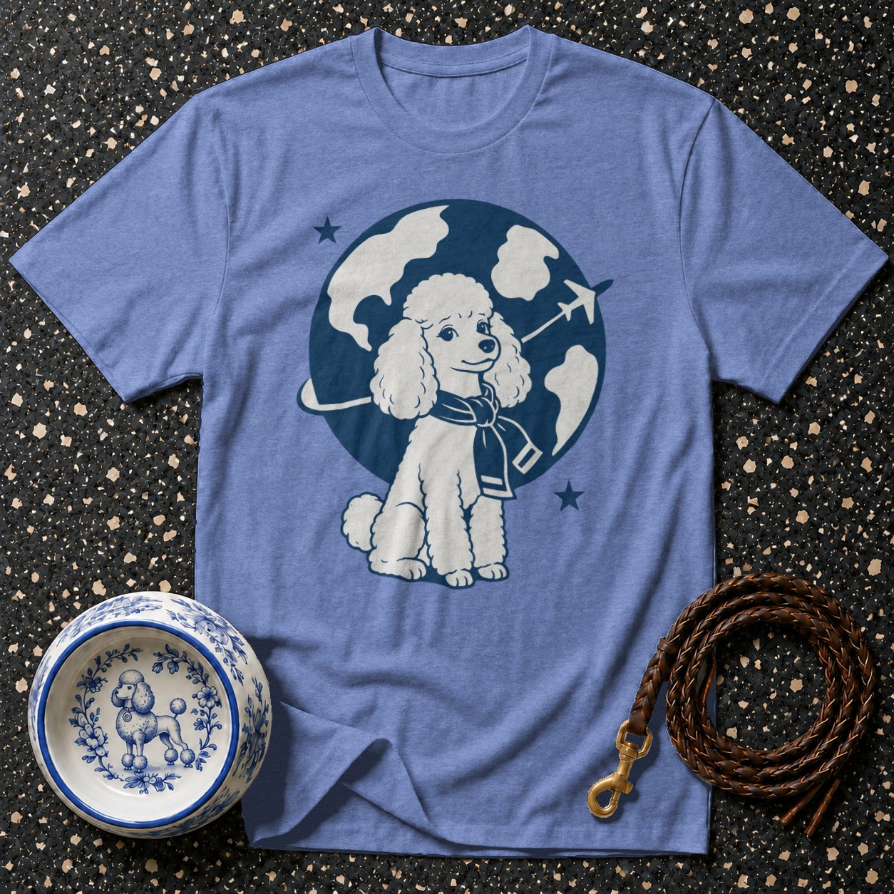 T-shirt with a white poodle wearing a scarf on a globe with an airplane.