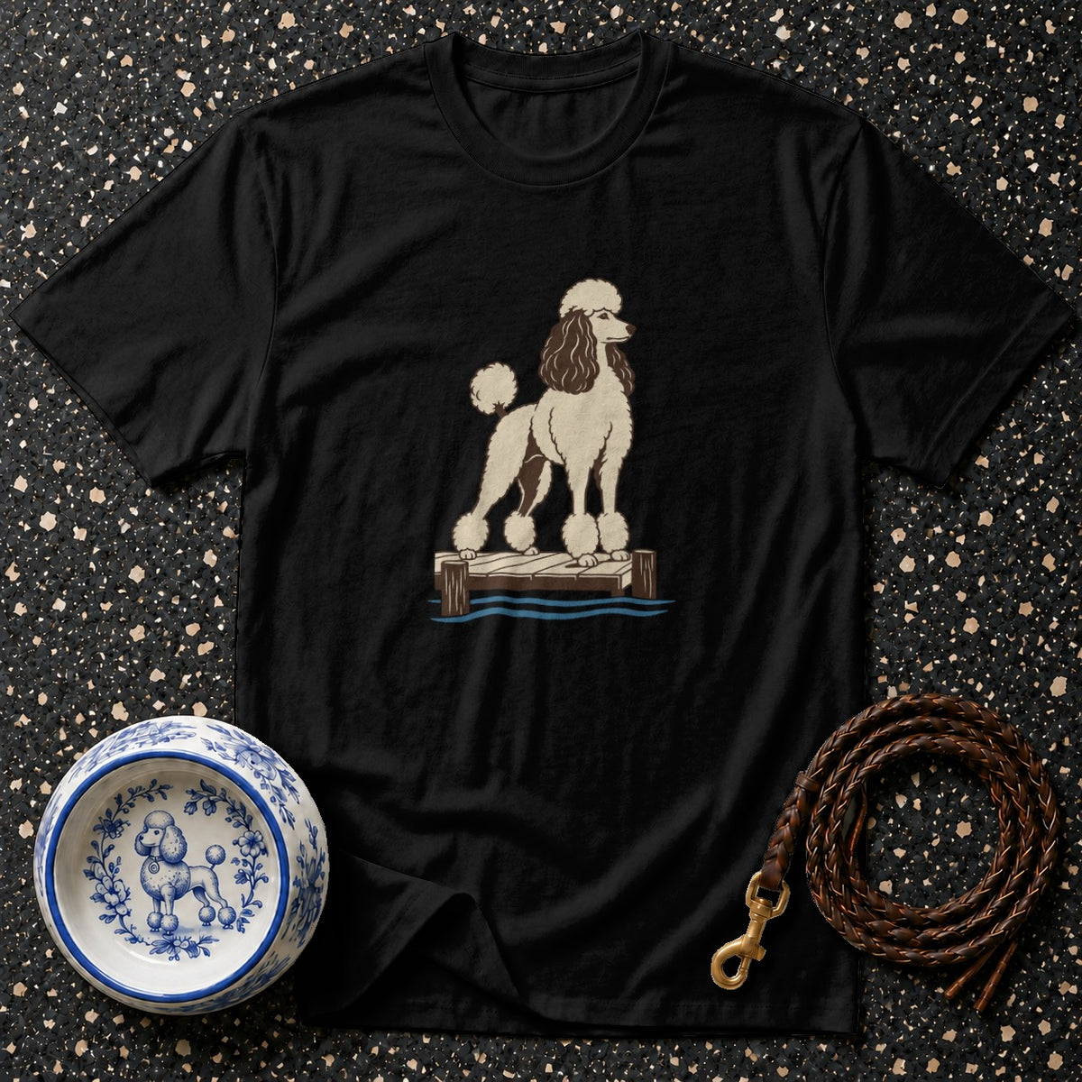 Black t-shirt with illustration of a cream and brown poodle on a dock.