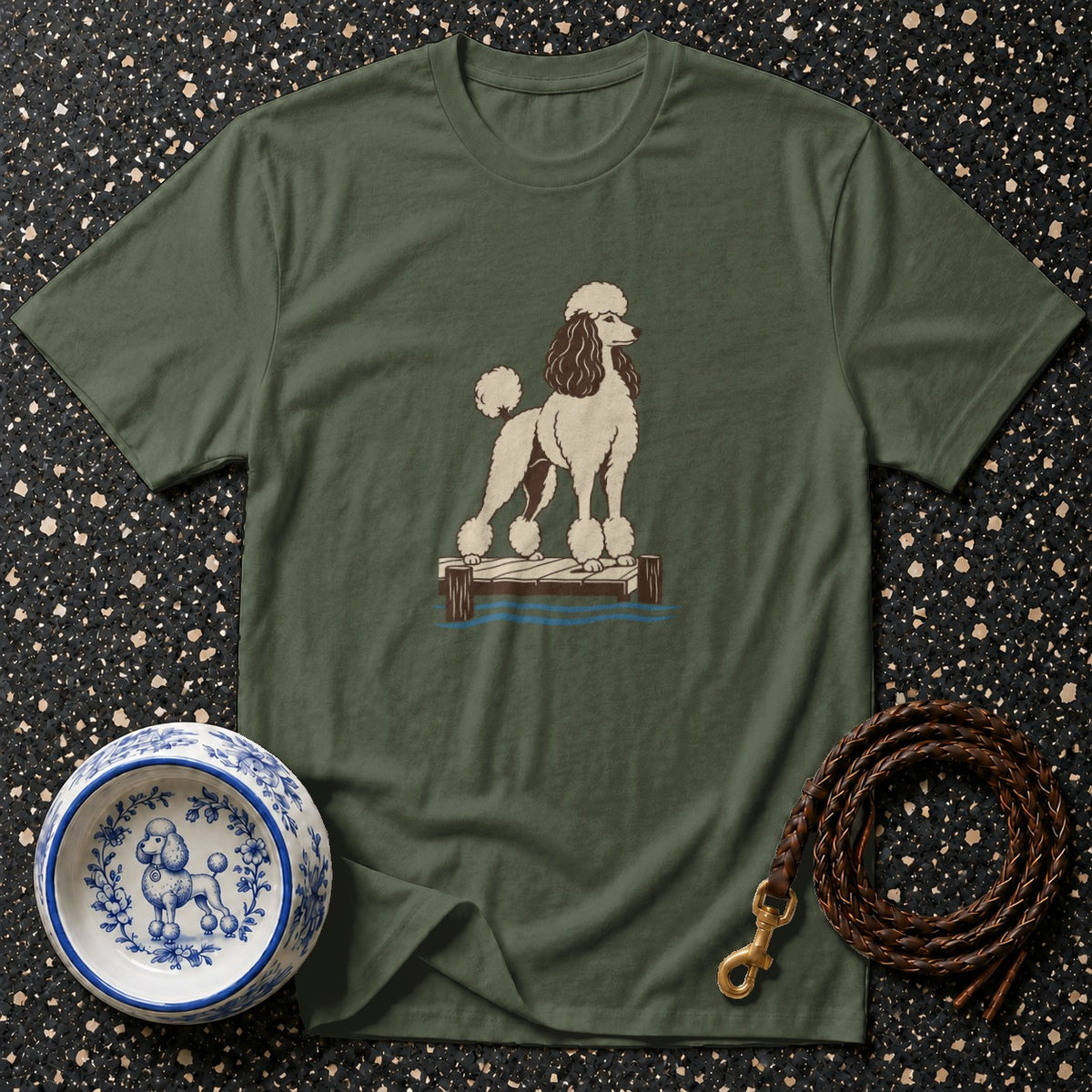 Green t-shirt with a poodle illustration standing on a dock.