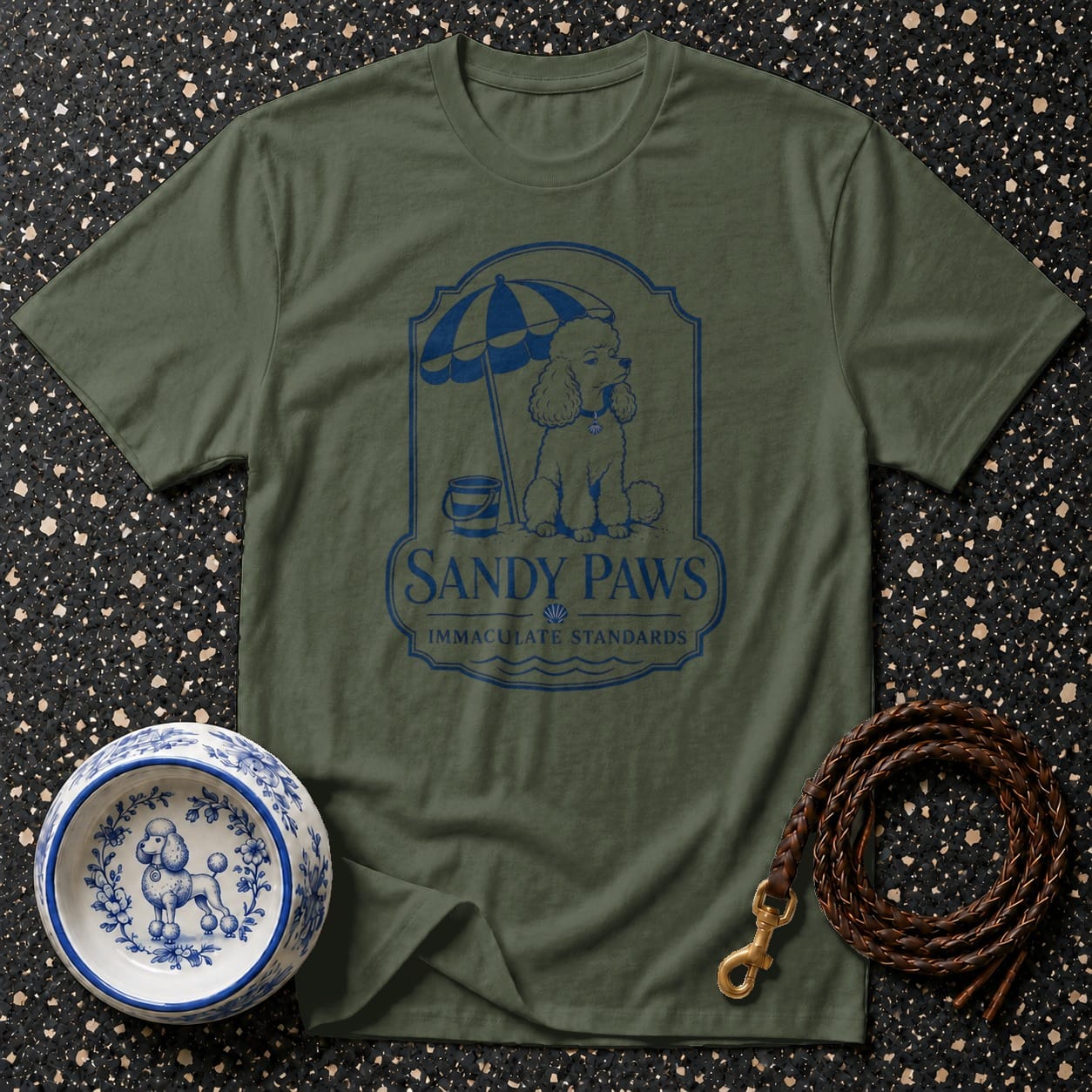 Olive t-shirt with blue Sandy Paws logo featuring a poodle under an umbrella.