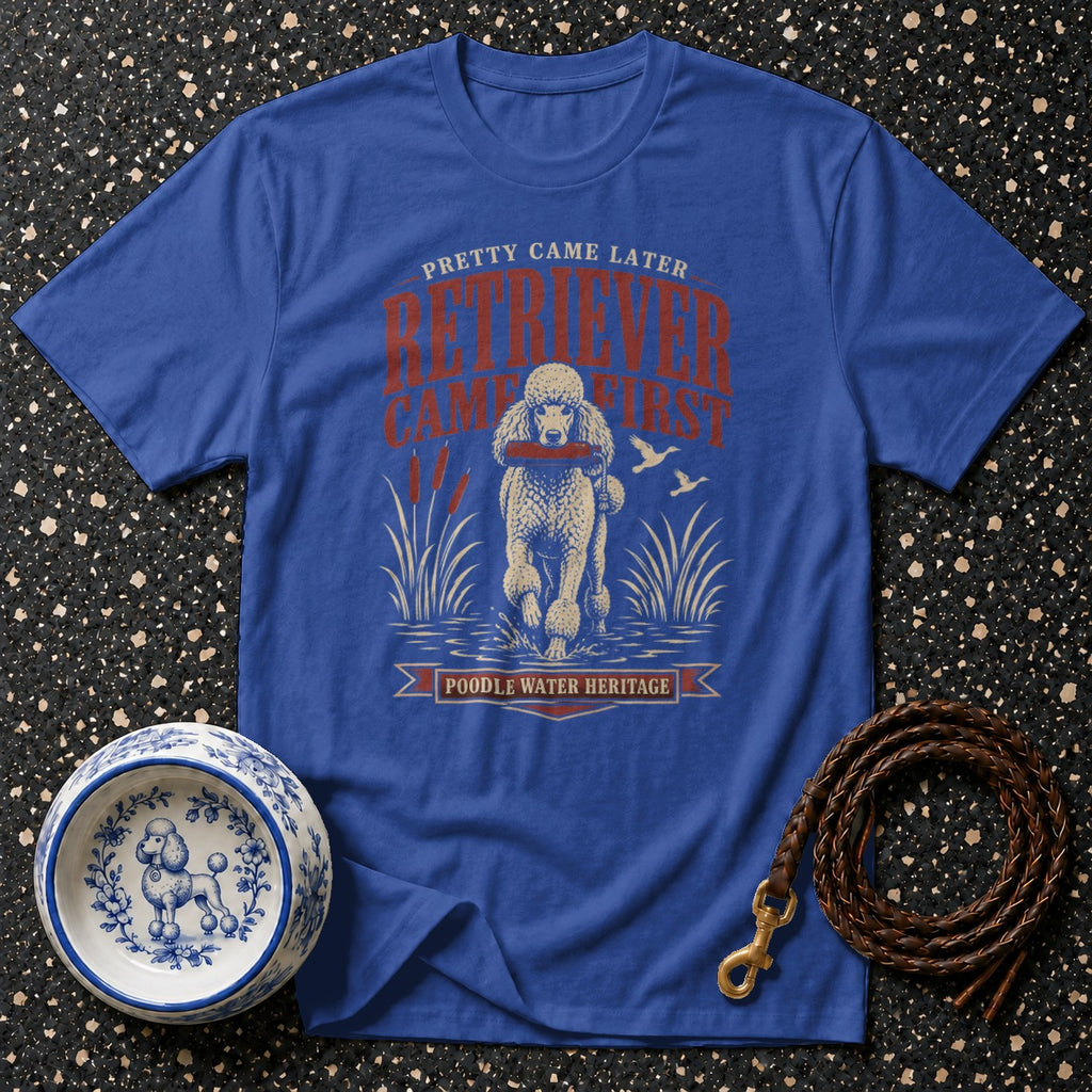 Blue t-shirt with a poodle in water holding a stick. Text reads "Pretty Came Later Retriever Came First Poodle Water Heritage".