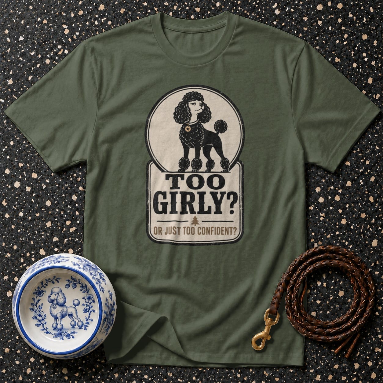 Green t-shirt with black poodle graphic and text "TOO GIRLY? OR JUST TOO CONFIDENT?".