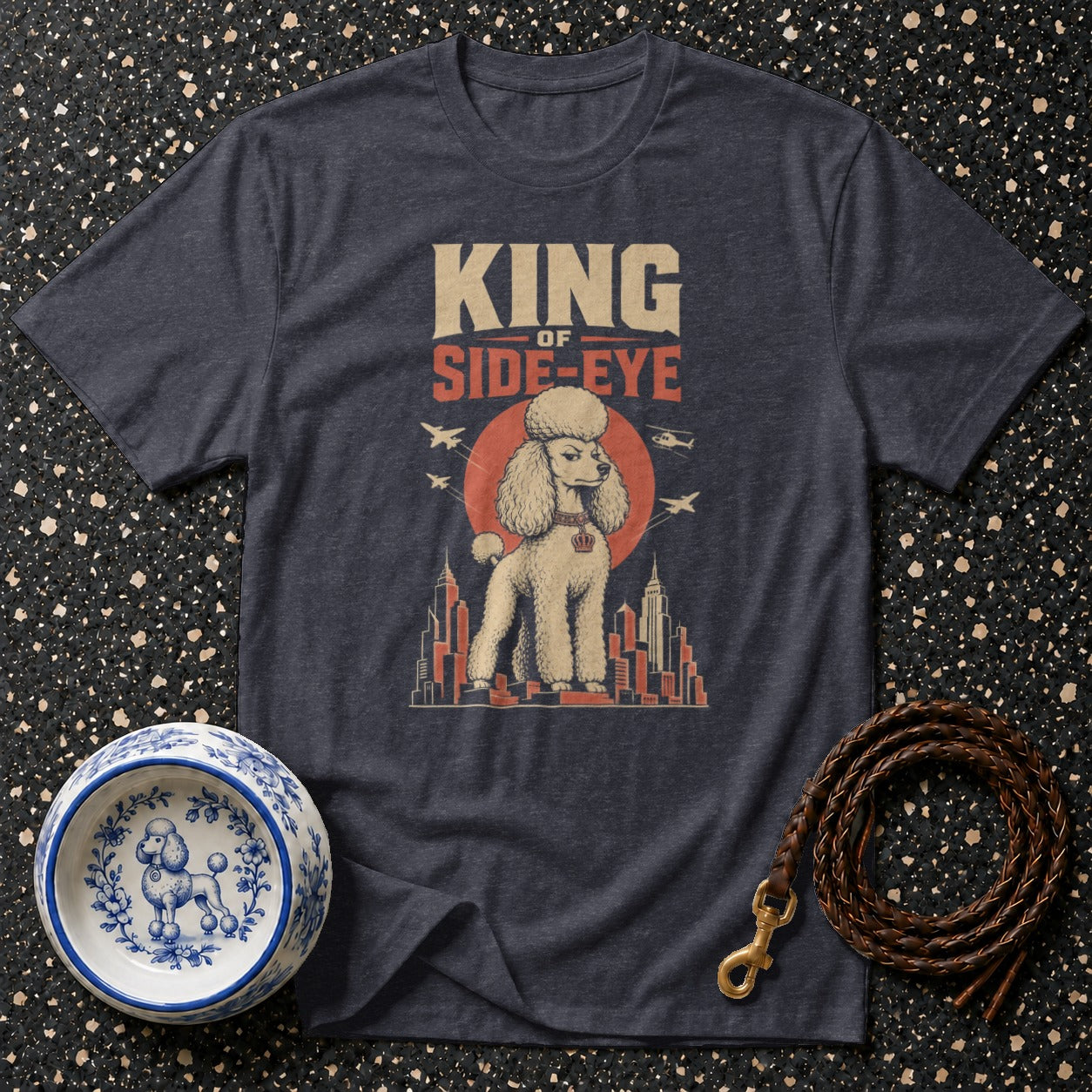 T-shirt graphic with poodle, buildings, planes, and text "King of Side-Eye".
