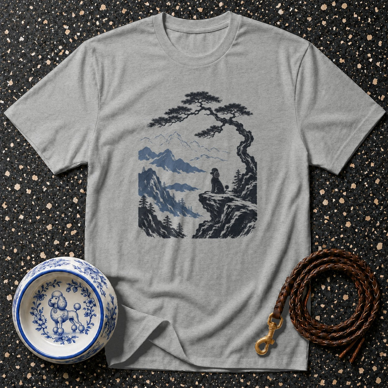 Gray t-shirt with poodle overlooking mountains under a stylized tree.