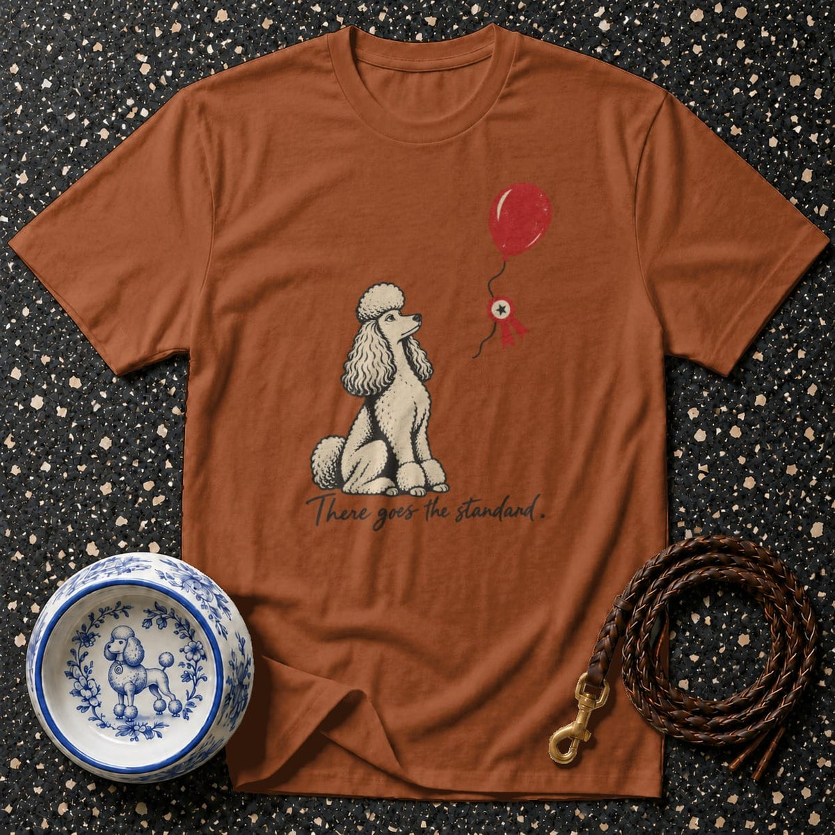 Brown t-shirt with a poodle graphic and text "There goes the standard."