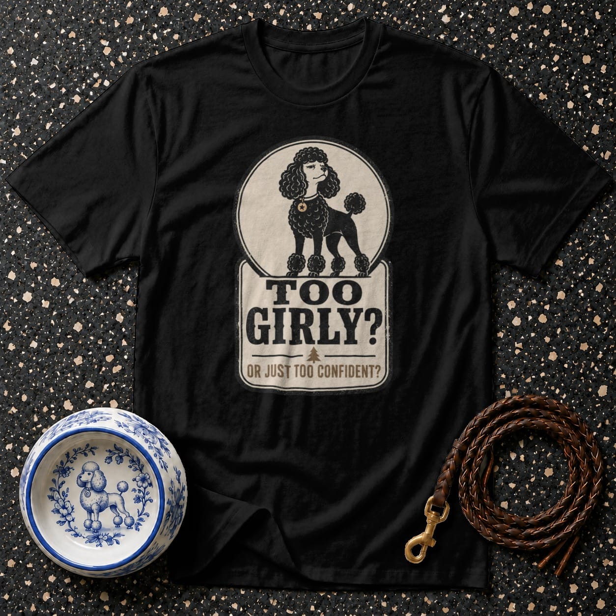 Black t-shirt with poodle graphic and text "TOO GIRLY? OR JUST TOO CONFIDENT?".
