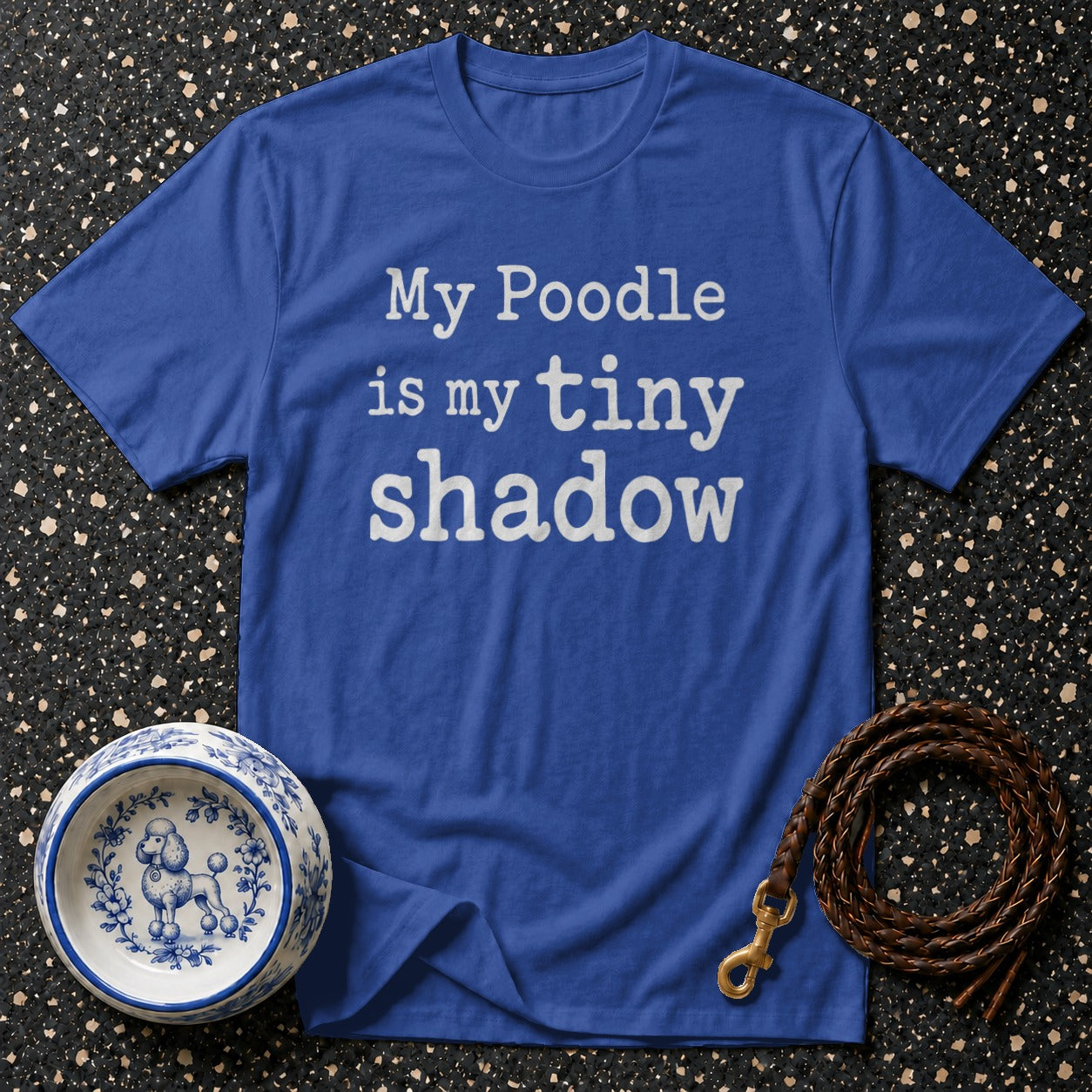 Blue t-shirt with white text "My Poodle is my tiny shadow" and dog bowl.