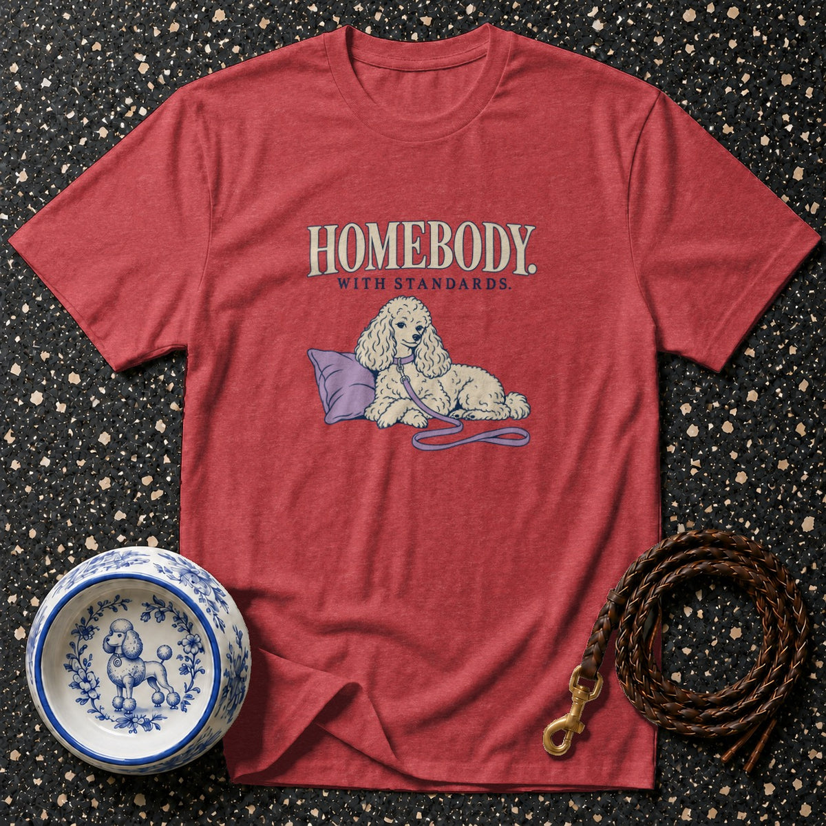 Red t-shirt with "HOMEBODY WITH STANDARDS" and poodle graphic, matching dog bowl, and leash.
