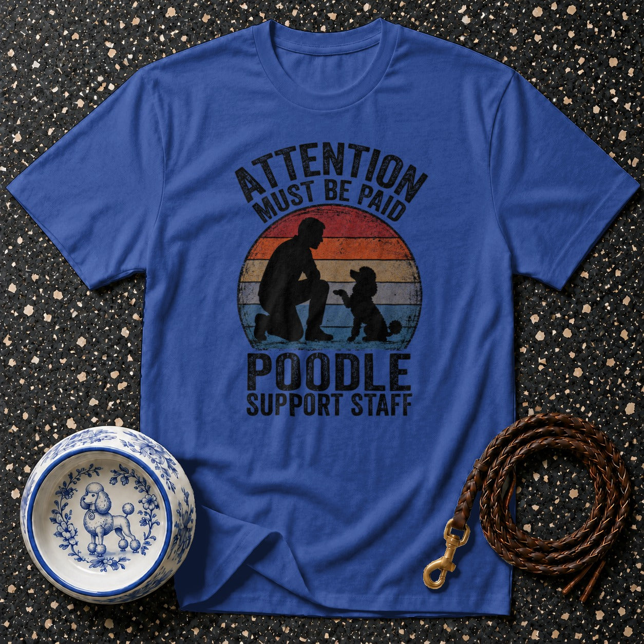 Blue t-shirt with "ATTENTION MUST BE PAID POODLE SUPPORT STAFF" graphic.