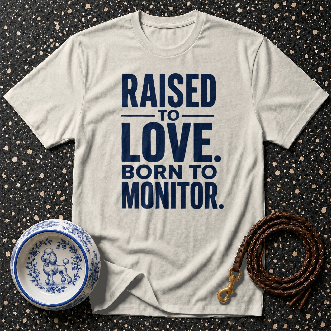 Cream t-shirt with navy text "RAISED TO LOVE. BORN TO MONITOR."