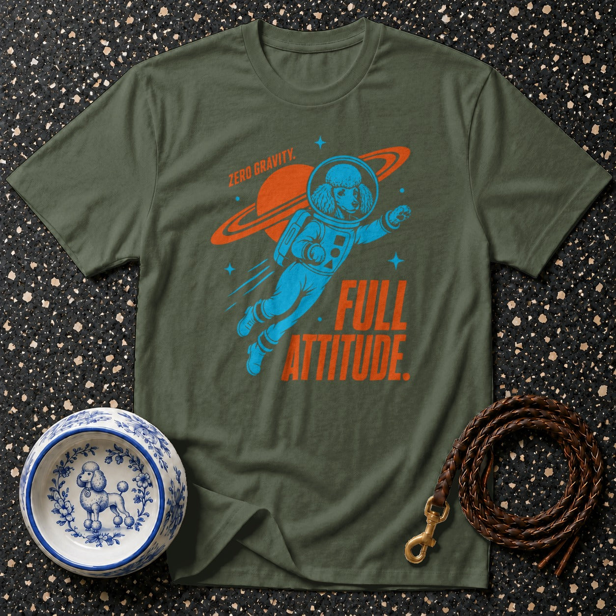 Olive green t-shirt with a blue poodle astronaut and orange text "ZERO GRAVITY. FULL ATTITUDE."