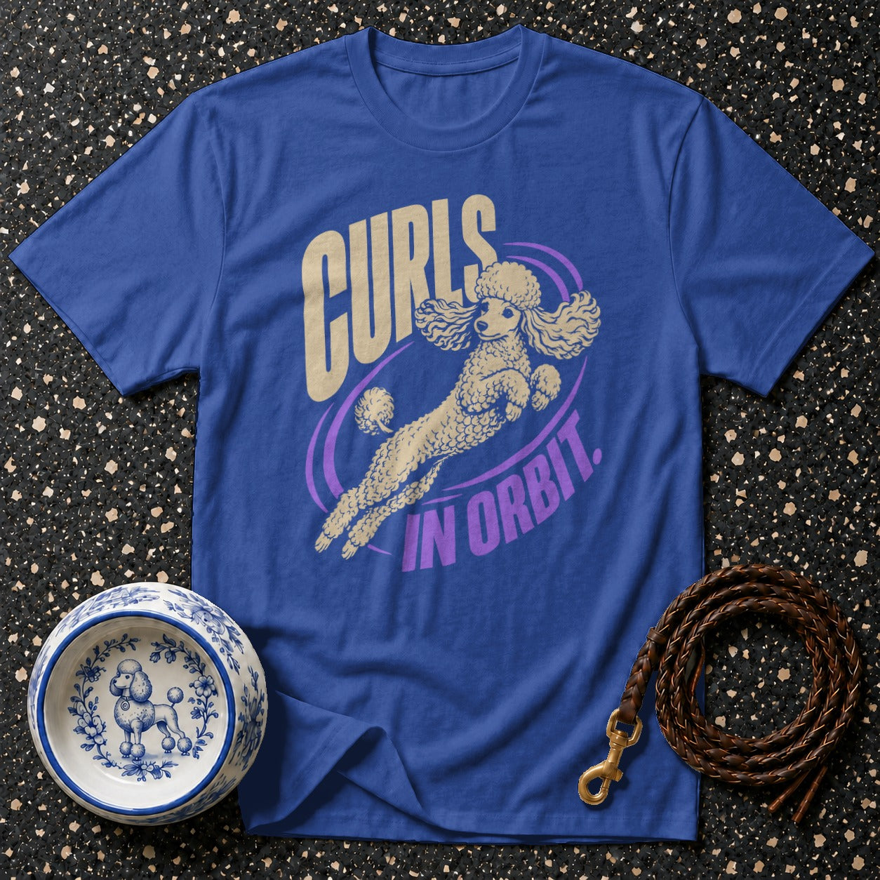 Blue t-shirt with poodle graphic and text "CURLS IN ORBIT"
