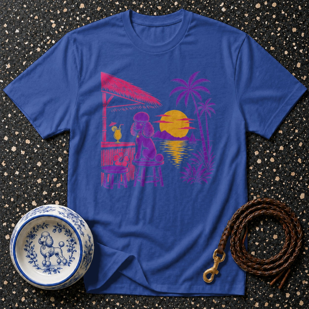 Blue t-shirt featuring a purple poodle at a tropical bar with a sunset and palm trees.