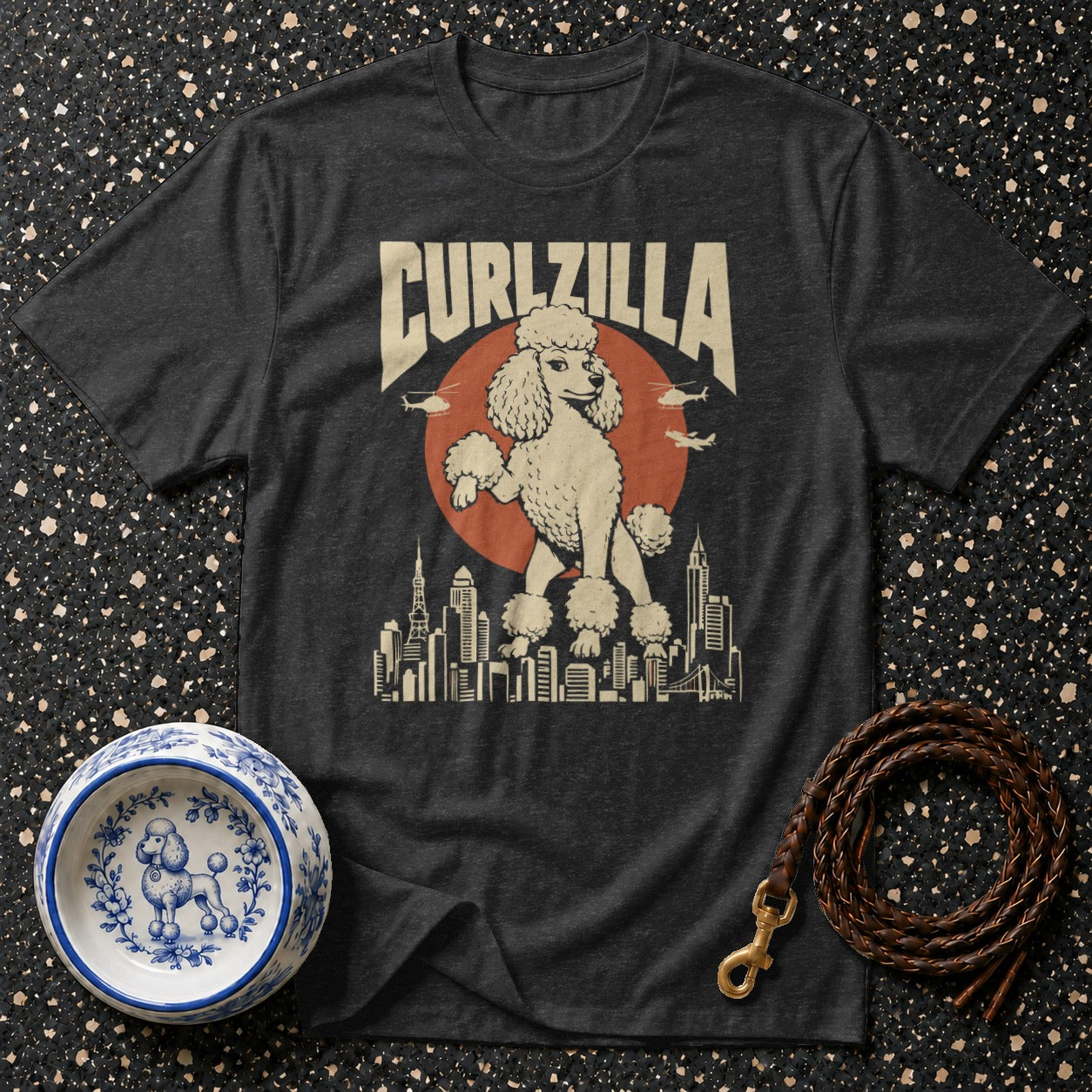 Dark t-shirt with "CURLZILLA" text above a poodle standing over a cityscape.