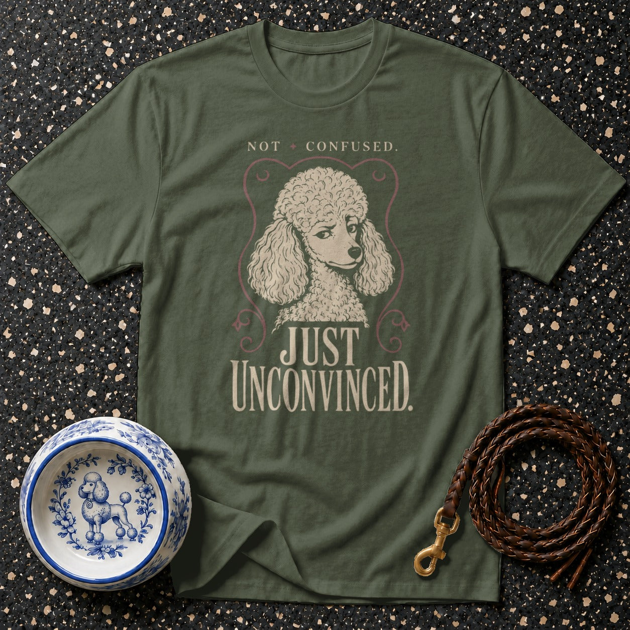 Green t-shirt with poodle graphic and text "NOT CONFUSED. JUST UNCONVINCED."
