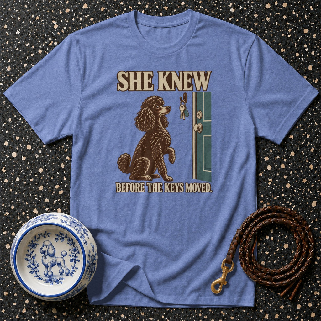Brown poodle with keys on door and text "She Knew Before The Keys Moved".