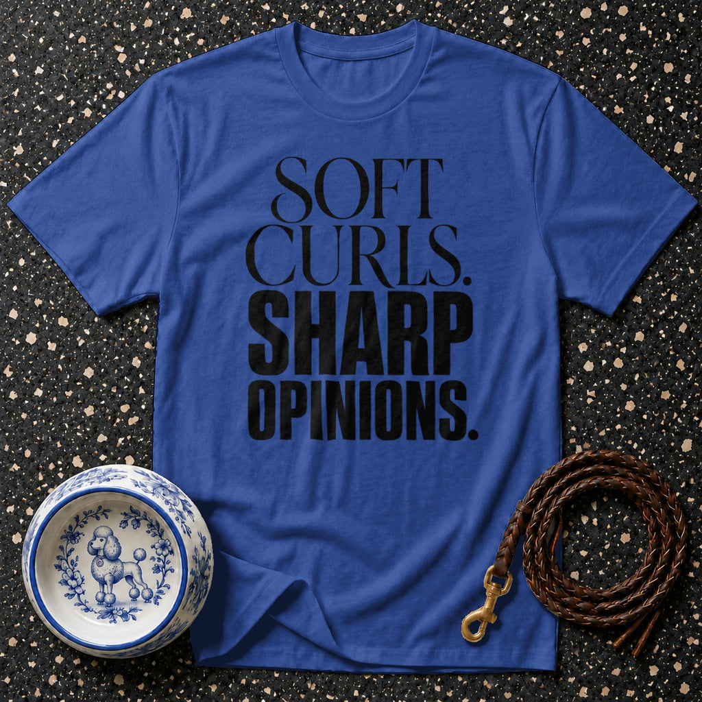 Blue t-shirt with black text reading "SOFT CURLS. SHARP OPINIONS."