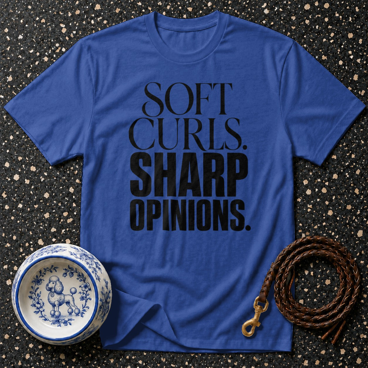Blue t-shirt with black text reading "SOFT CURLS. SHARP OPINIONS."