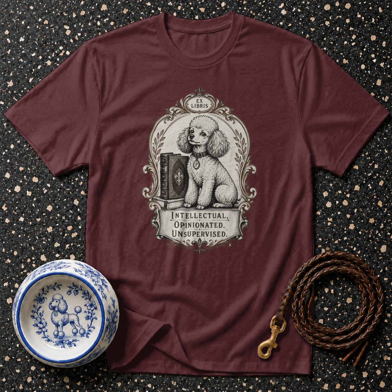 Maroon t-shirt with poodle and books graphic, reads "EX LIBRIS INTELLECTUAL, OPINIONATED, UNSUPERVISED."