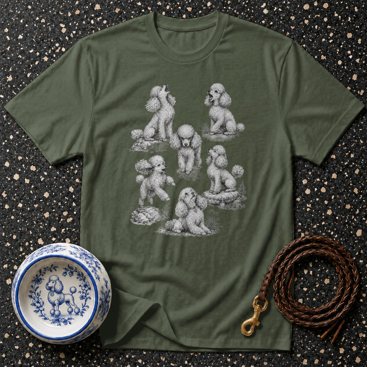 T-shirt with multiple poodle drawings, a ceramic dog bowl, and a leather leash.