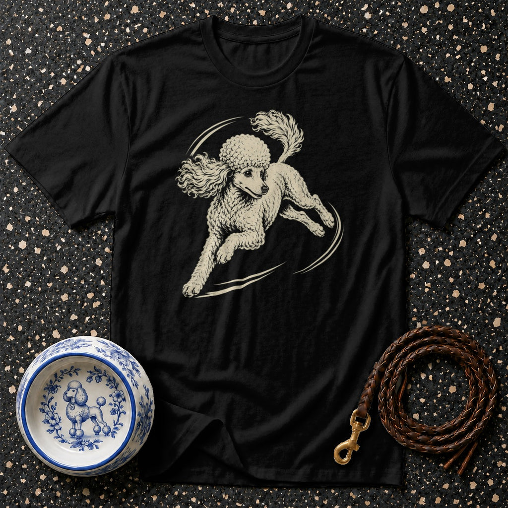 Black t-shirt with a cream-colored poodle illustration, beside a poodle-decorated bowl and leather leash.