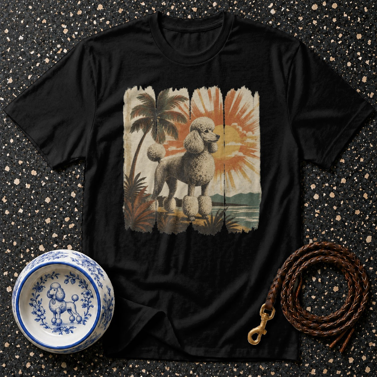 Black t-shirt with vintage poodle and tropical sunset graphic.