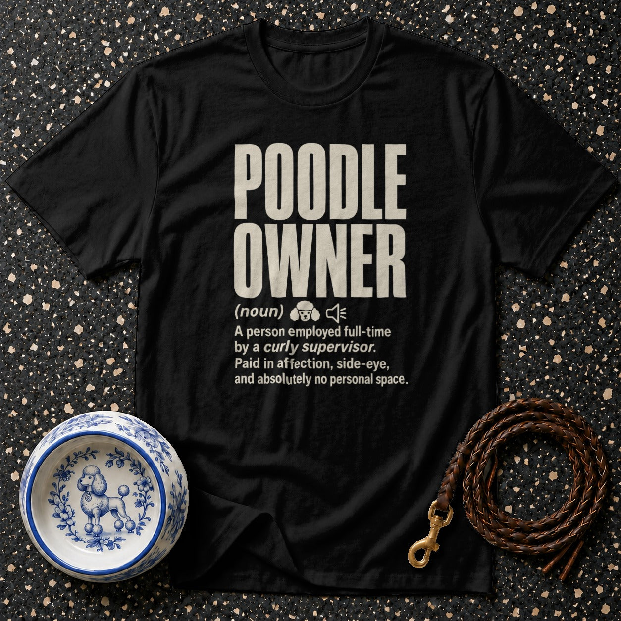 Black t-shirt with "POODLE OWNER" definition, a poodle-decorated bowl, and braided leash.