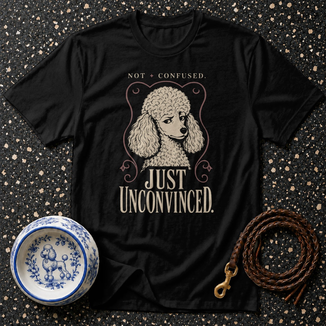 Black t-shirt with poodle graphic and text "NOT CONFUSED. JUST UNCONVINCED."