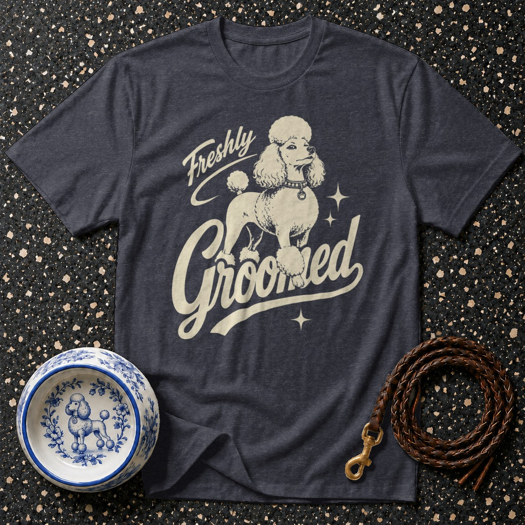 Dark t-shirt with graphic of a poodle and text that reads "Freshly Groomed".