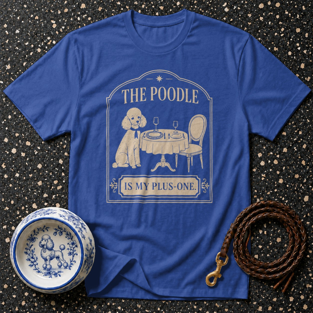 Blue t-shirt with a poodle at a table graphic and text "THE POODLE IS MY PLUS-ONE."