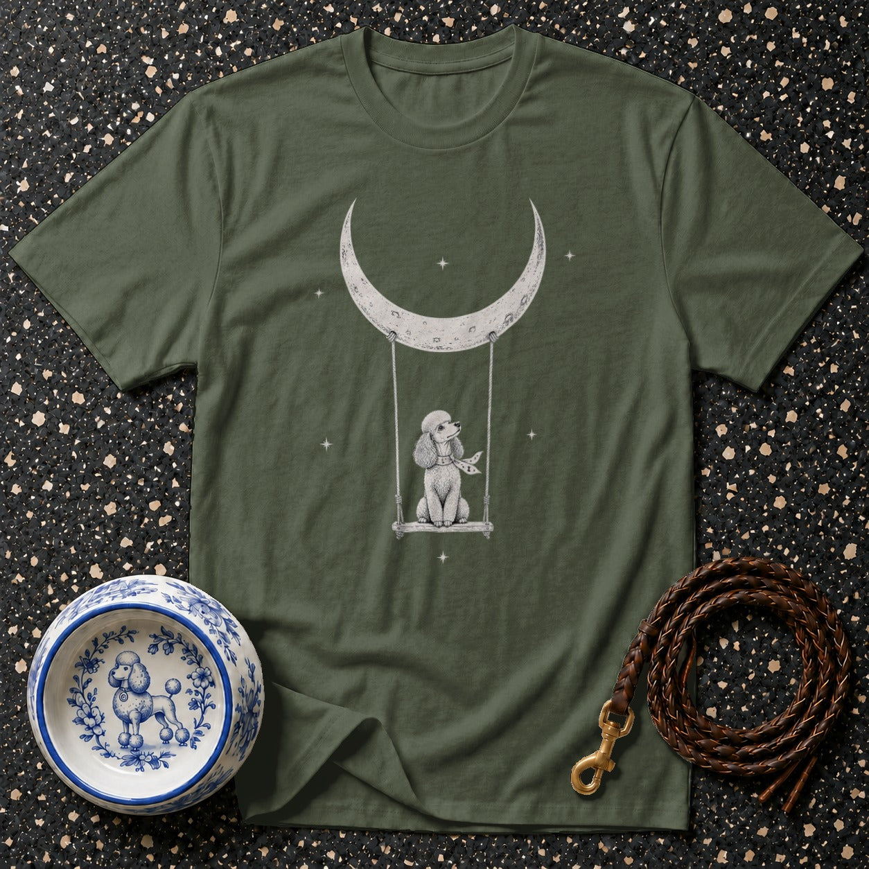 Green t-shirt with a poodle on a swing under a crescent moon and stars.