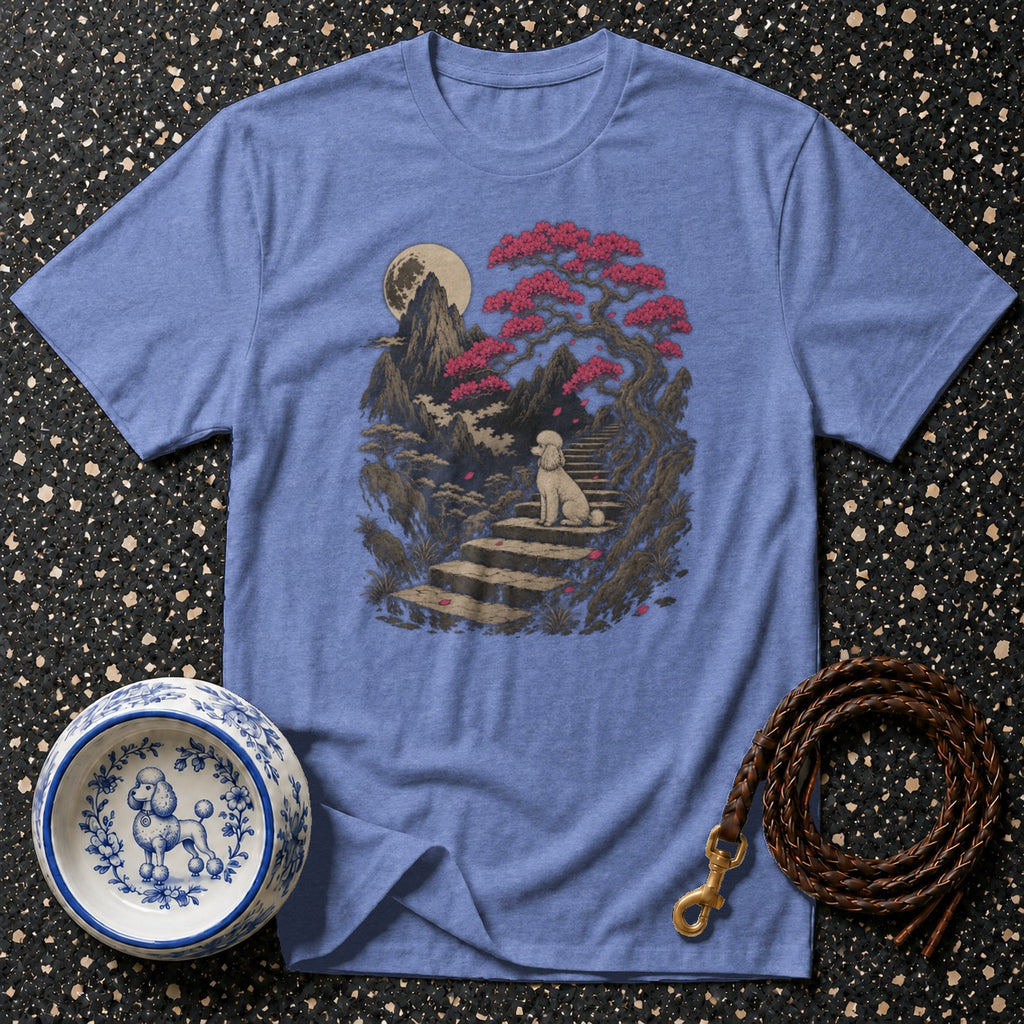 Blue t-shirt with a stylized landscape featuring a white poodle sitting on stairs.