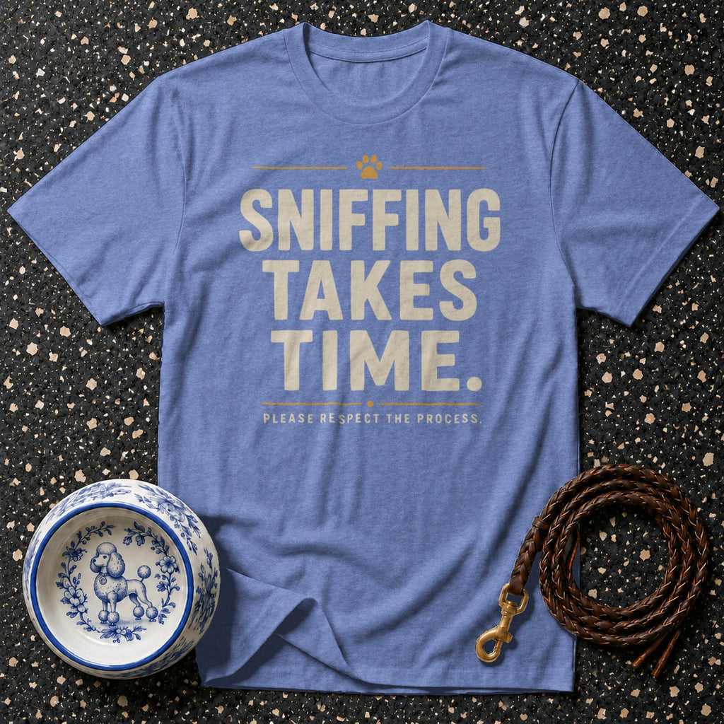 Blue t-shirt with "Sniffing Takes Time" and a paw print.