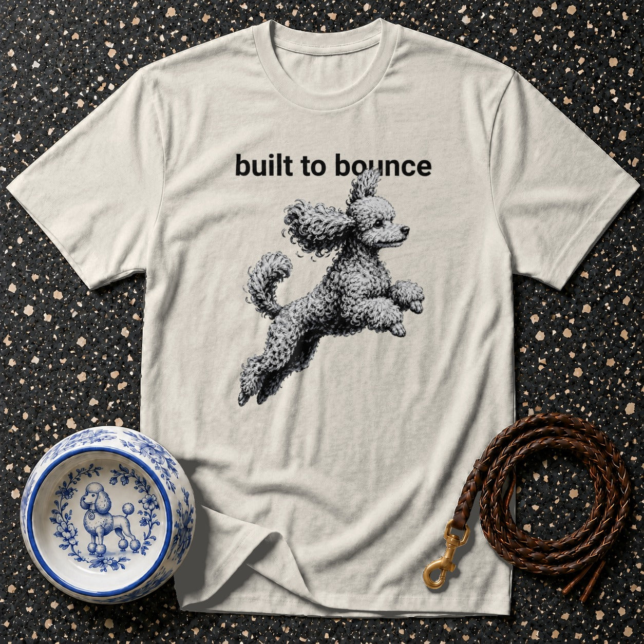 T-shirt with "built to bounce" text and a jumping poodle graphic.