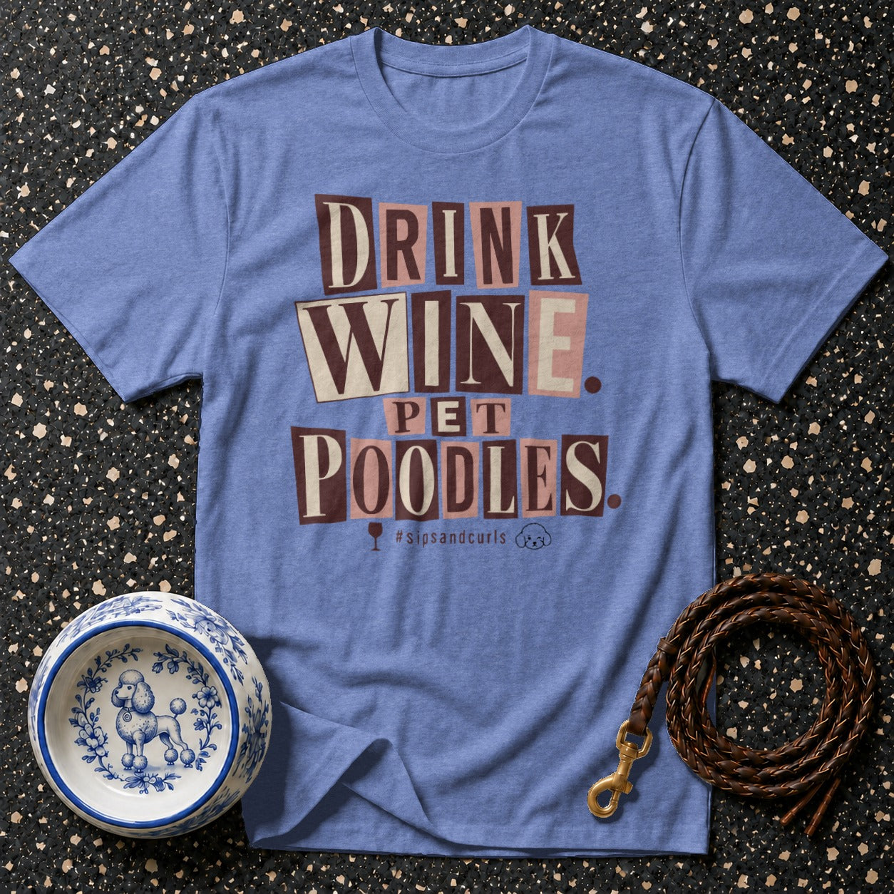 Blue t-shirt with text "DRINK WINE PET POODLES" and poodle bowl.
