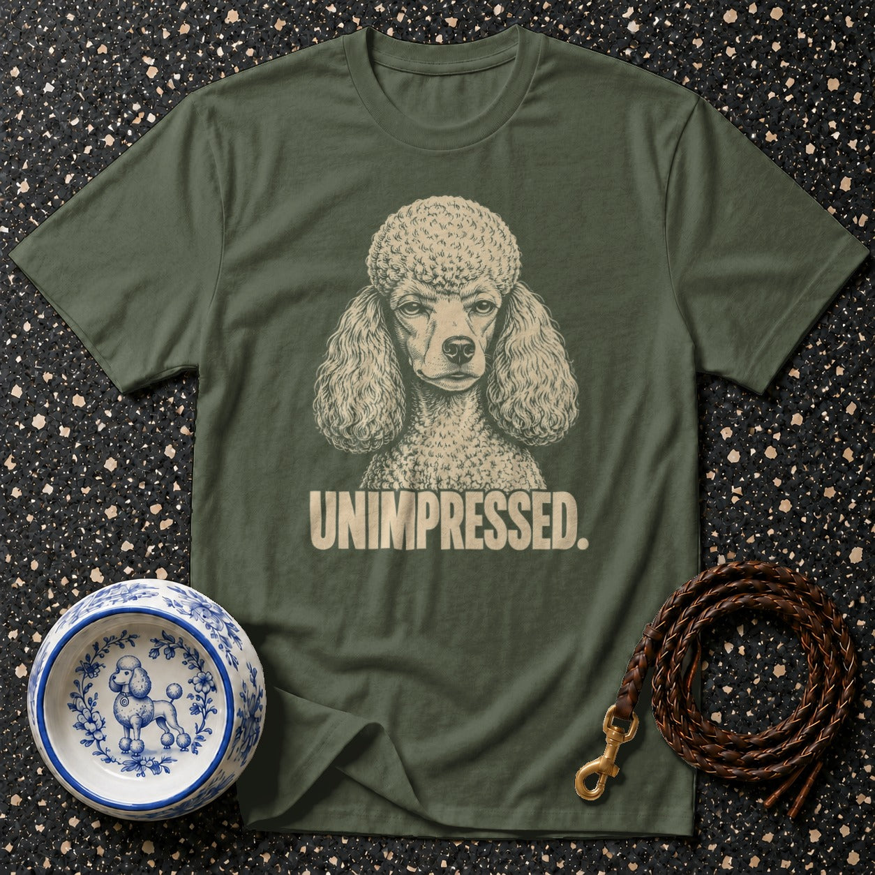 Olive green t-shirt with a poodle graphic and "UNIMPRESSED." text.