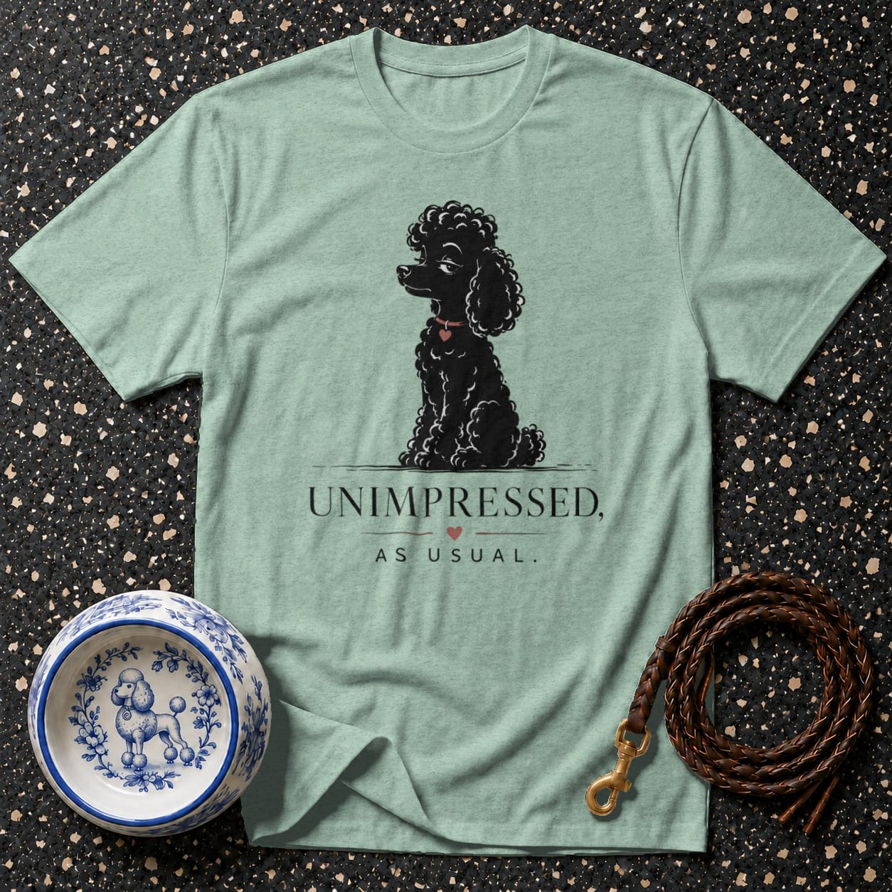 Mint t-shirt with black poodle graphic and text "UNIMPRESSED, AS USUAL."
