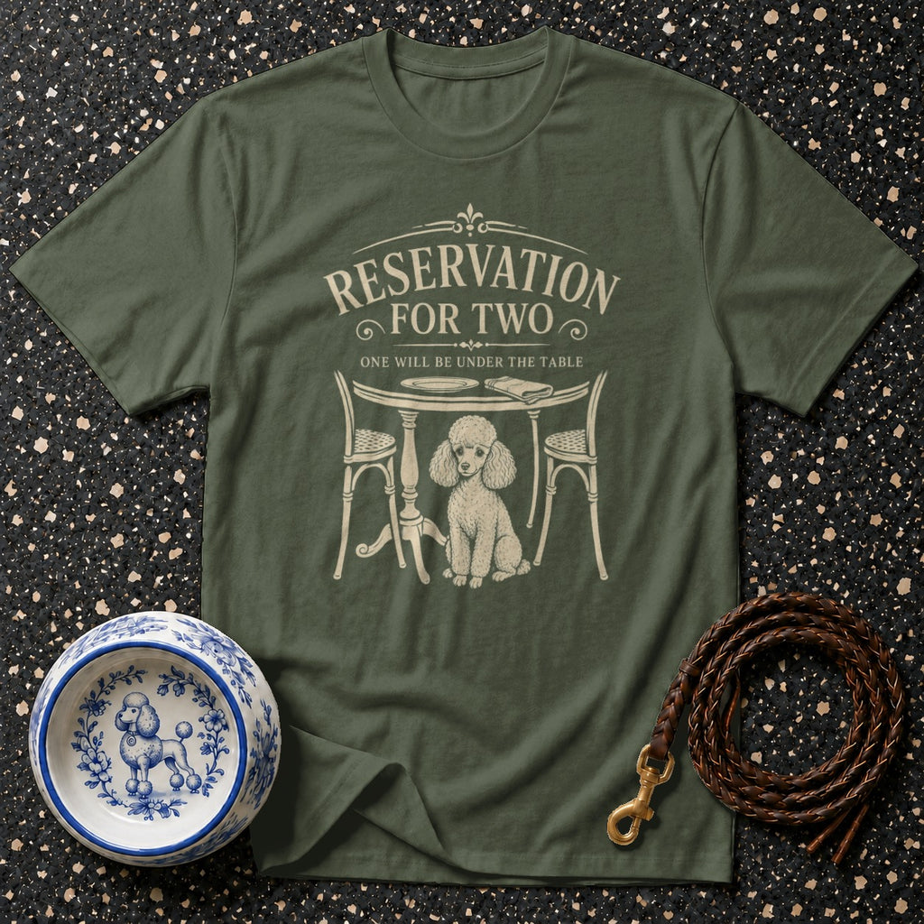 Green t-shirt with cream graphic of a poodle under a table that reads "Reservation For Two".