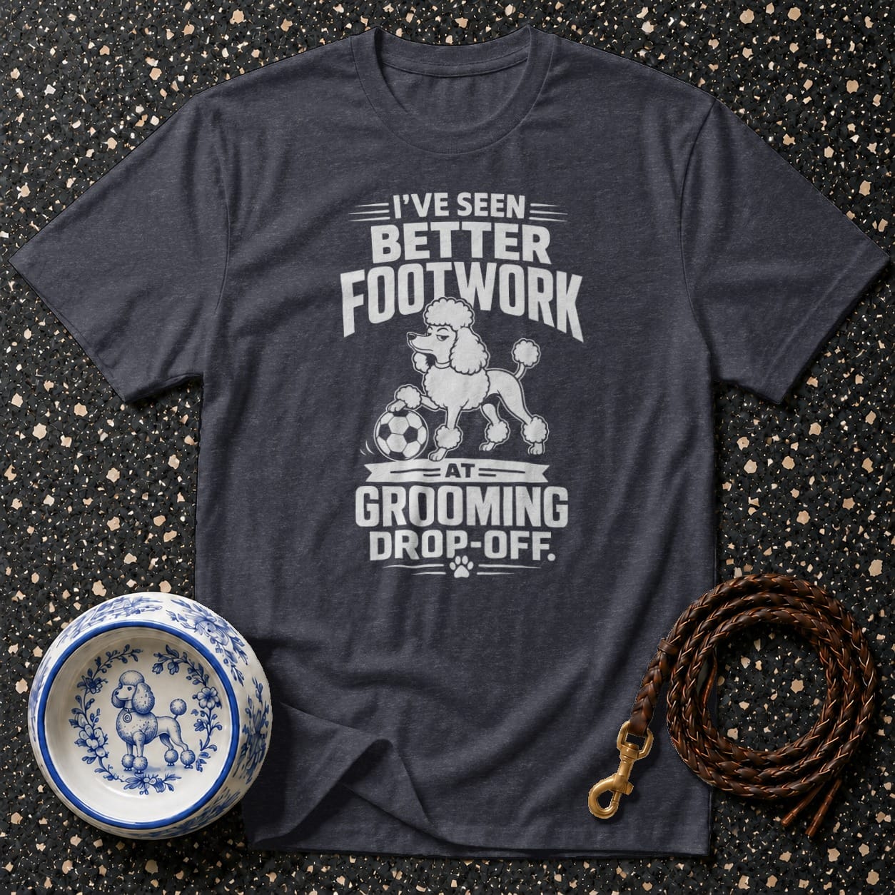 Dark grey t-shirt with white text and poodle graphic: "I've seen better footwork at grooming drop-off."