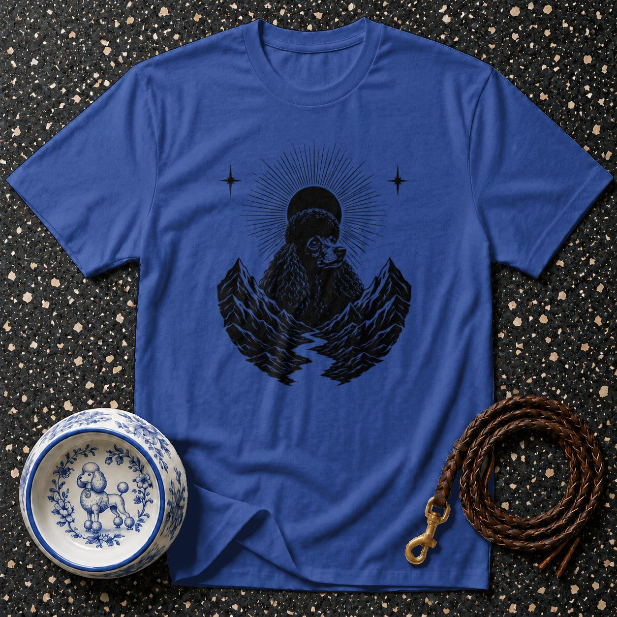 Blue t-shirt with black poodle, mountains, and sun graphic.
