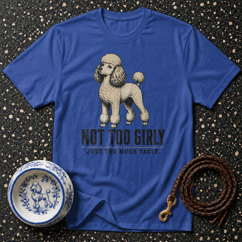 Blue t-shirt with a poodle graphic and text "NOT TOO GIRLY JUST TOO MUCH TASTE."